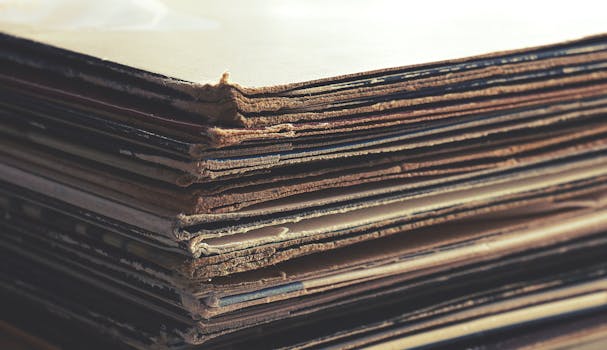 Close-up image of stacked vintage cardboard sheets with worn edges.